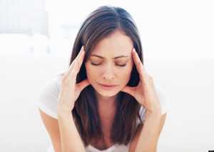 Portrait of stressed woman having head pain